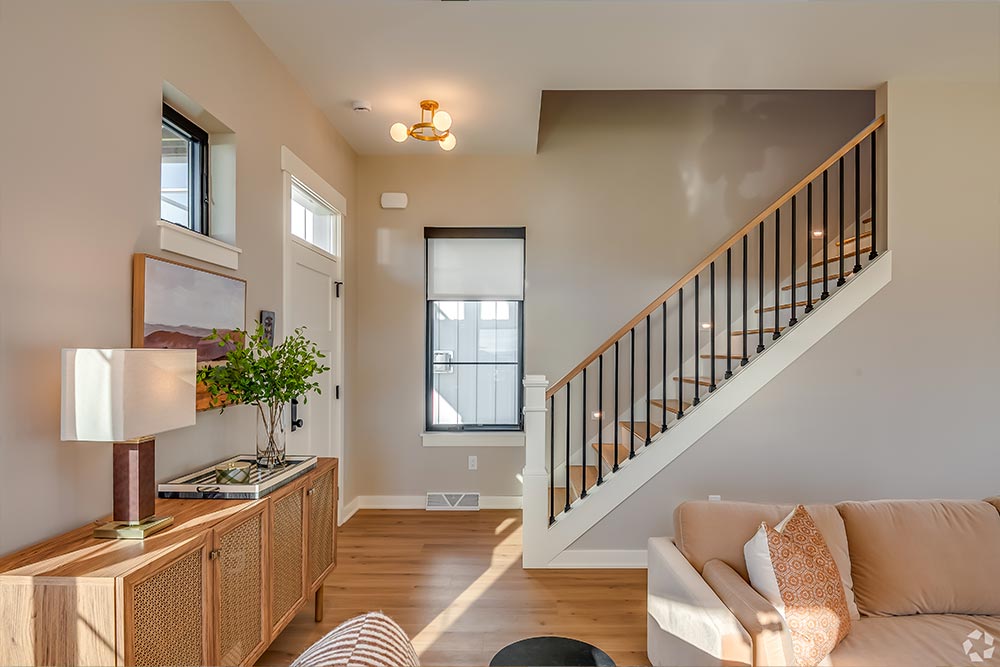 Living room and stairway in Dublin Model at Prairie's Edge - Port Washington, WI